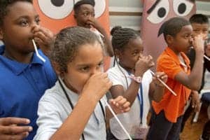 Children drinking from straws during a science demonstration at CAES News.