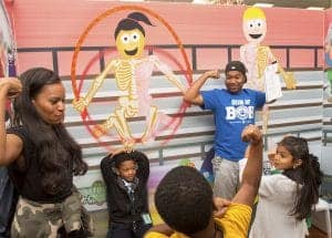 Children and adults enjoying a skeleton dance activity at CAES News event.