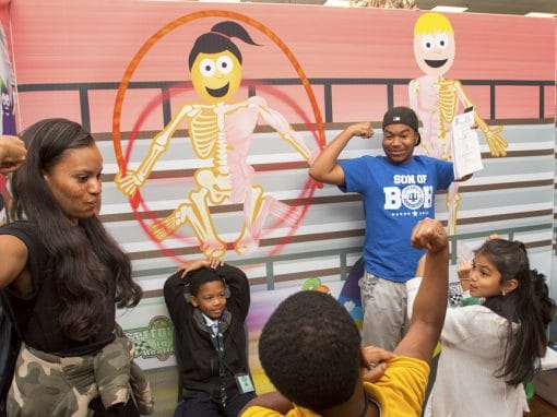 Children and adults enjoying a skeleton dance activity at CAES News event.