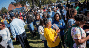 Community gathering at outdoor event in a park.