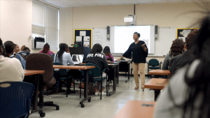 Teacher conducting a lesson in a classroom setting at CAES News.