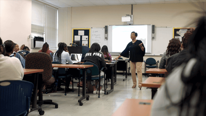 Teacher conducting a lesson in a classroom setting at CAES News.