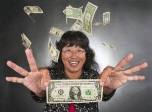 Money raining over happy woman with dollar bills flying around.