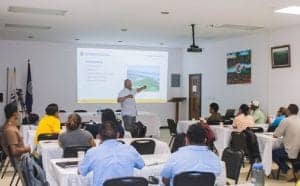 Expert speaker presenting at a conference on sustainable development and environmental conservation.