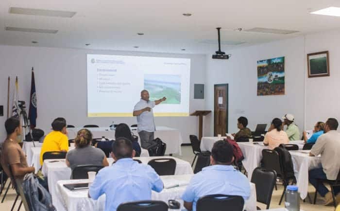 Expert speaker presenting at a conference on sustainable development and environmental conservation.