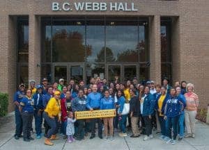 A vibrant group of students and faculty gathered outside B.C. Webb Hall for a college agriculture an.