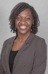 Professional African American woman smiling in business attire for CAES News.