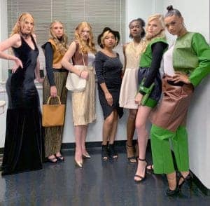 Elegant diverse group of women in fashionable outfits posing in a modern indoor setting for a fashio.