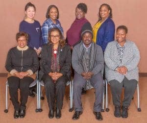 Diverse group of professionals posing together in a formal setting for CAES News.