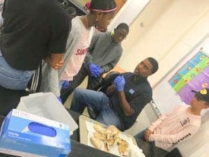 Medical professionals and students discussing a surgical procedure in a clinical setting.