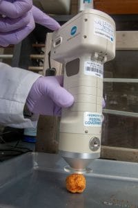 High-precision laboratory instrument analyzing a sample in a scientific research setting.