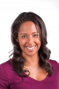A woman smiling in a professional portrait for news and media coverage.
