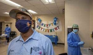 COVID-19 healthcare workers celebrating retirement event in medical facility.