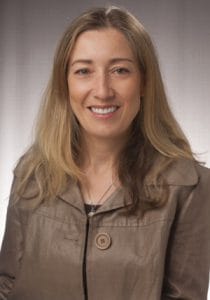 A woman smiling in a professional portrait for CAES News.