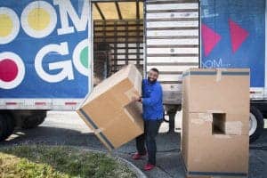 Moving boxes being unloaded from a truck for a relocation or delivery.