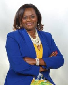 Empowered woman in a blue blazer smiling confidently for CAES News.