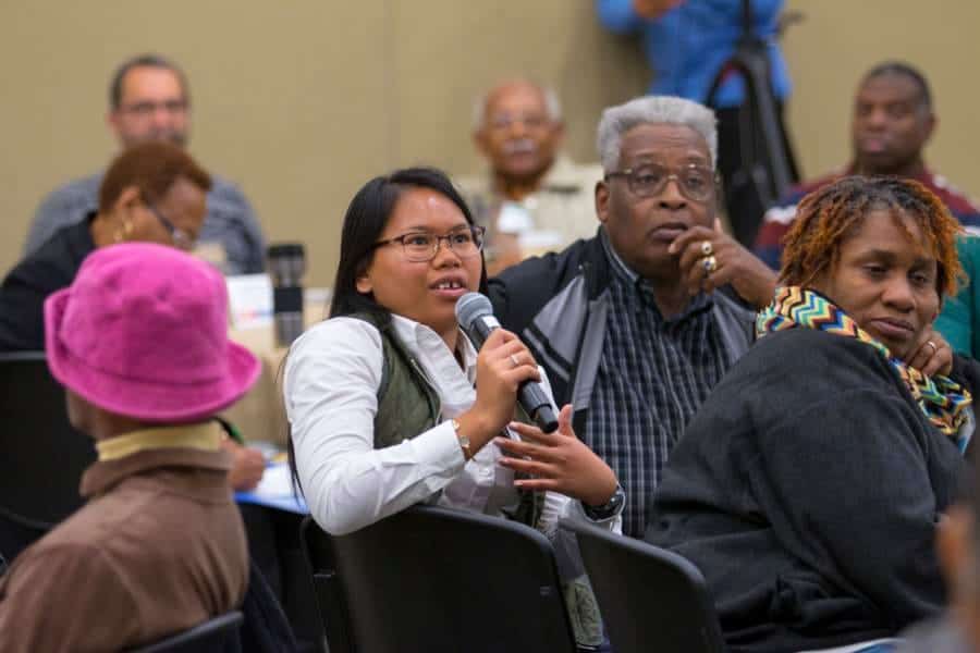 Engaged diverse group of people participating in a community discussion or workshop.