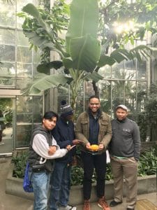 From left to right: 4-Hers Joshua Puac-Puac and Qudre Joyner, 4-H Agent Guy Holly (with cacao pod), and 4-H Agriscience Associate Kurt Taylor at the U.S. Botanical Garden in January 2020.