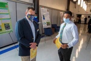 COVID-19 safety protocols at a professional conference or event in a modern indoor setting.