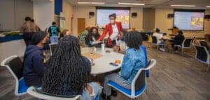 Diverse group of students and instructor in a classroom during a workshop or seminar.