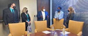 High-level business meeting with diverse professionals in a conference room, discussing strategies.