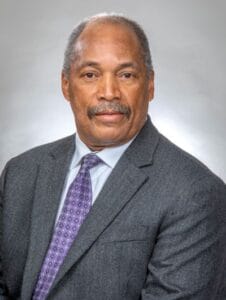 Professional African American man in suit for business or news interview.