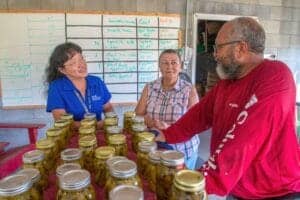 Freshly canned jars displayed at a community event in a rural setting.