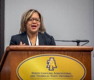 Empowered woman speaking at podium with North Carolina Agricultural and Technical State University l.