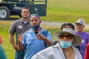 Engaging outdoor community discussion with diverse group of people at a park event.