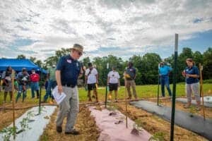 Community leaders and volunteers participate in a groundbreaking ceremony for a new sustainable agri.