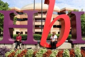 Explore the vibrant CAES campus with students and large colorful university signage.