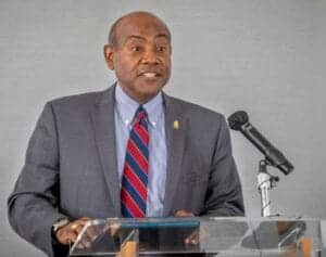 Empowered African leader speaking at a conference on economic development and leadership.