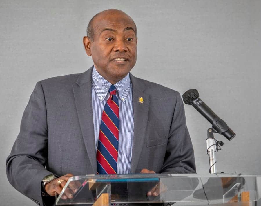 Empowered African leader speaking at a conference on economic development and leadership.