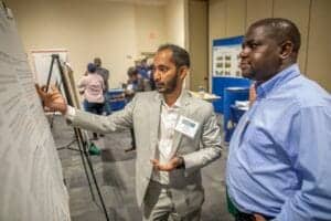 Innovative conference presentation with diverse professionals discussing research findings.