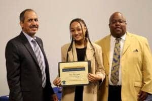 Graduation ceremony with diverse students and faculty celebrating academic achievement.