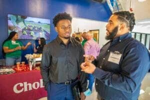 Engaged professionals discussing at a conference or networking event.