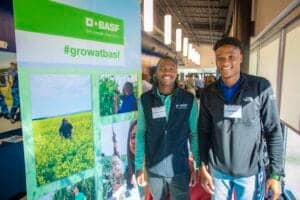 BASF #growatbasf event with two young men smiling at the booth.