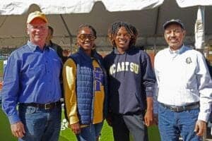 Celebrating diversity at CAES News event with smiling group of four people outdoors.