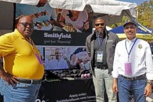 Enjoying a food festival at the Smithfield booth with diverse attendees and promotional materials.