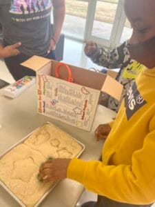 Children engaging in baking or cooking activity with ingredients and tools.