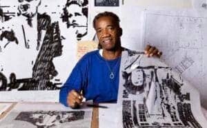 Artist working on black and white sketches in a creative studio.