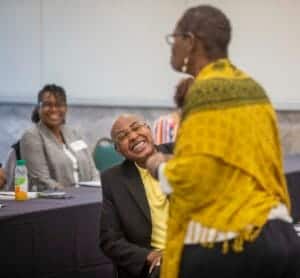 Empowered women engaging in a professional discussion at a conference or seminar.