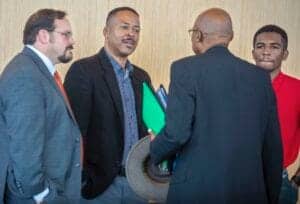 Engaged business professionals in a discussion at a corporate event or conference.