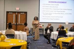 CAES News event with speaker addressing attendees in a conference room.