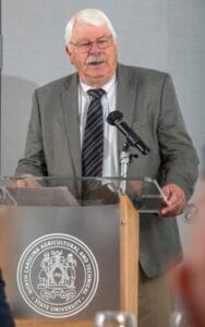 A senior man speaking at a podium during a formal event at North Carolina Agricultural and Technical.