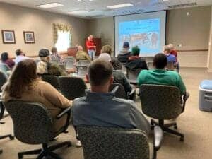 Audience attending a wildlife conservation presentation at CAES News event.