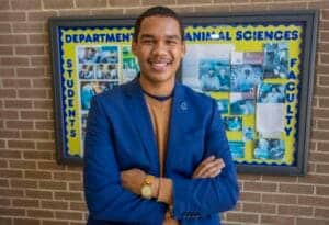 A person standing in front of a bulletin board for the Department of Animal Sciences.
