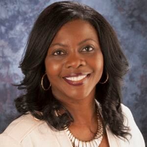 Empowered African American woman smiling, professional headshot for CAES News.