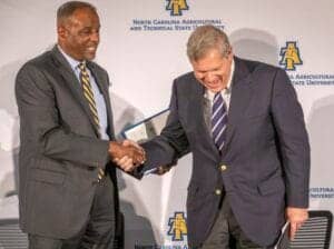 Two men shaking hands at North Carolina Agricultural and Technical State University event.
