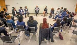 Diverse group of professionals in a meeting discussing business strategies.